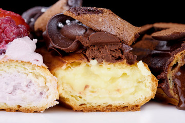 Delicious dessert on a white background. A fresh and tasty eclair is isolated on a white background, with beautiful decor.