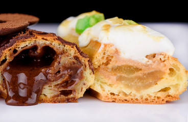 Delicious dessert on a white background. A fresh and tasty eclair is isolated on a white background, with beautiful decor.