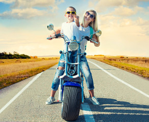 Mother and son rides on motorbike.	