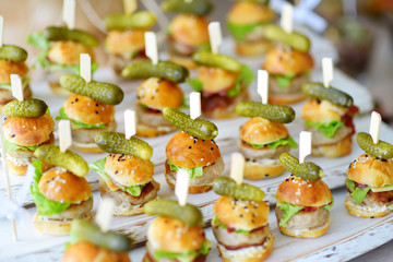 Delicious one bite mini burgers served on a party or wedding reception.