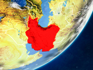 Iran on model of planet Earth with country borders and very detailed planet surface and clouds.