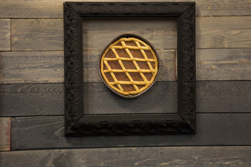 Apricot Jam Tart in a Frame, Wooden Background