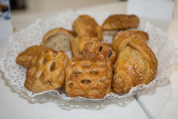 Doughnuts and Brioches for Breakfast Piled up on a Round Tray