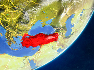 Turkey on model of planet Earth with country borders and very detailed planet surface and clouds.