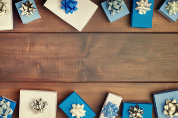 Christmas composition, beautiful frame. Small blue and white gift boxes, with beautiful silver bows. Copy space. Holiday card.