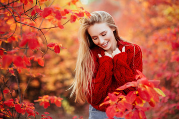 Close up portrait of a Beautiful girl near colorful autumn leaves.