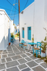 Paved alley with tables and chairs in Chora. Serifos island, Greece