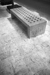 Concrete bench of Santo Domingo street in Colonial Zone. Bench is lit with soft sun light falling...