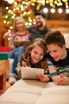 brother and sister   lying and writes letter to Santa Claus for Christmas.