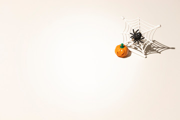 Composition of plastic toys for Halloween, with pumpkin, spider, cobweb, snake and bones