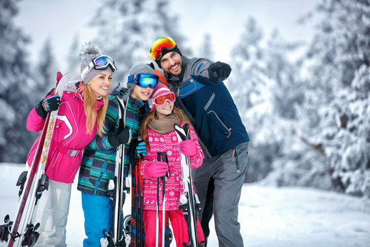 Skiing, winter, snow, sun and fun - family enjoying holiday vacations
