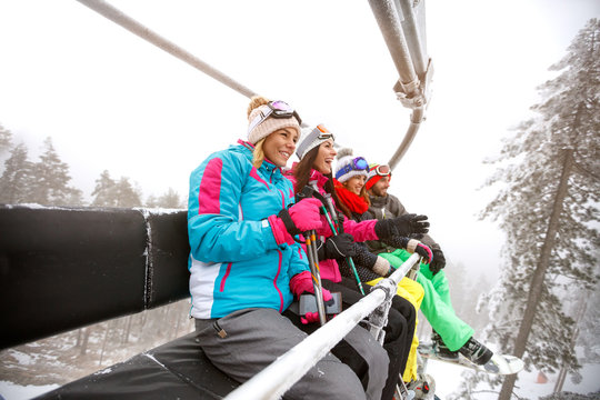 Group of skiers in ski lift on mountain