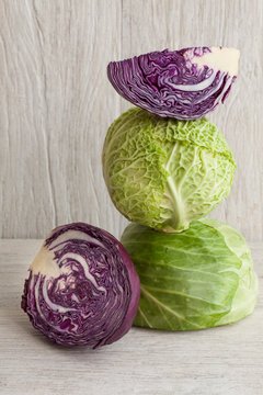 Cabbages stacked on rustic white background