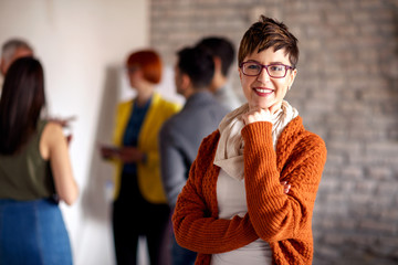 Portrait of businesswoman with colleagues.