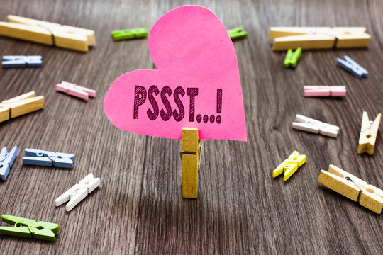 Writing note showing Pssst.... Business photo showcasing Expression Way to attract attention of someone Be quiet Silence Clothespin holding pink paper heart several clothespins wooden floor