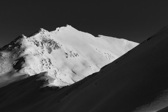 Black and white mountain peakc overed with snow in the Swiss Alps, Graubuenden, Switzerland.