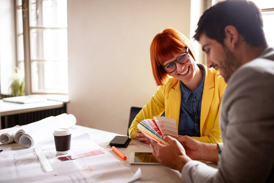 Professional designers looking at color swatches. - Powered by Adobe