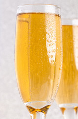 Glasses of Champagne on a Silver Glitter Backdrop