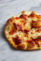 Crispy Cracker Thin Pizza with Air Bubbles on Marble