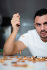 Portrait of a man who spills nuts on the table. concept of a healthy lifestyle