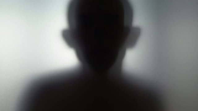 Scary human behind frosted glass in 4k slow motion 60fps