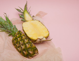 Half cut juicy pineapple on a pastel pink background. Minimal su