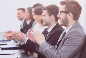 Fototapeta premium cheering business team sitting at Desk
