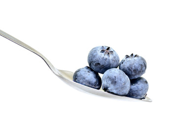 blue berry on spoon isolated on white background
