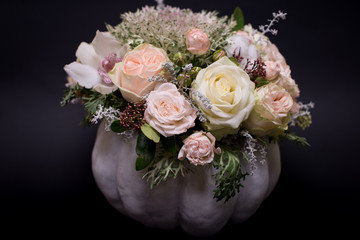 flower bouquet in a white pumpkin on a black background, a mixture of flowers, peony rose, eucalyptus, chrysanthemum, Brassica, white orchid, cotton