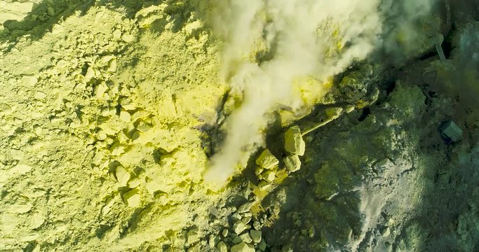 Aerial view of crater Ijen volcano with evaporation of sulfur dioxide gas where sulfur is mined. 4K