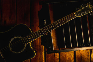 Obraz na płótnie Canvas acoustic guitar and a chair