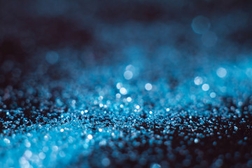 Blue abstract bokeh on a black background. Defocused.