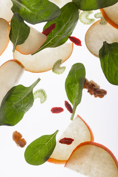 Apple slices, spinach leaves and nuts