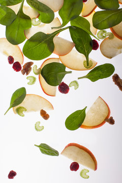 Apple slices, spinach leaves and nuts