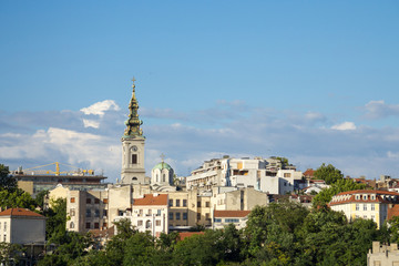 Fototapeta na wymiar Panorama of the old city of Belgrade with a focus on Saint Michael Cathedral, also known as Saborna Crkva, with its iconic clocktower seen from afar. belgrade is the capital city of Serbia