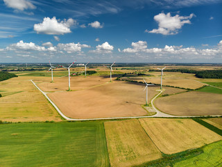 Aerial view of wind turbines generating power, located in Lithuania, on summer day.