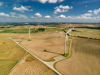 Aerial view of wind turbines generating power, located in Lithuania, on summer day.