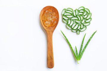 Aloe vera gel on wooden spoon with aloe vera slices heart shaped on white background