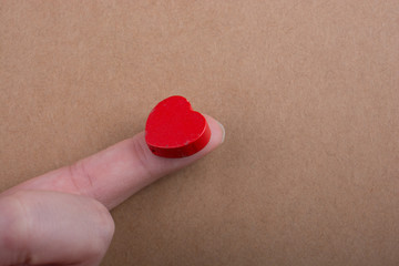 Red color heart shaped object ion finger
