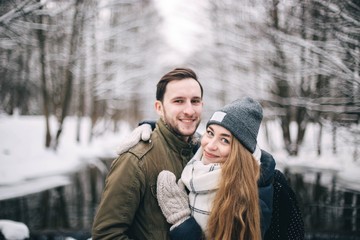 couple in love in the winter forest in the frost. Clothes in the cold season.