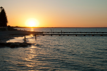 Fototapeta na wymiar Busselton Australia, Sunset over Geographe Bay with ocean bathes in foreground