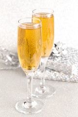 Glasses of Champagne on a Silver Glitter Backdrop
