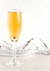 Glass of Champagne on a Silver Glitter Backdrop