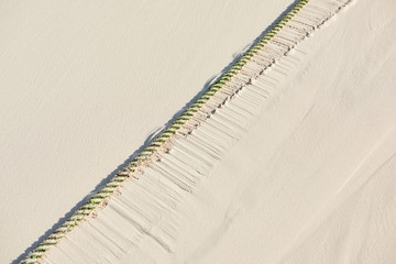 Rope motion marks on tha sand of ocean beach in Bavaro, Punta Cana made by waves in sunny day in season of rains. Punta Cana, Dominican Republic. Photo for background