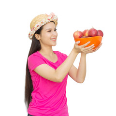 Portrait of lovely young woman holding a fresh ripe apple in bowl and smiling isolated on white background with clipping path. Healthy eating concep.