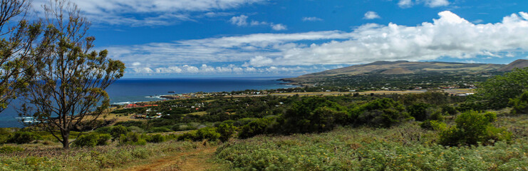 Naklejka na ściany i meble Panoramic view of Easter Island, a tourist destination in Chile, showing its natural characteristics, relief, vegetation and archaeological sites. Rapa Nui, moai, archeology, ancient isla pascua
