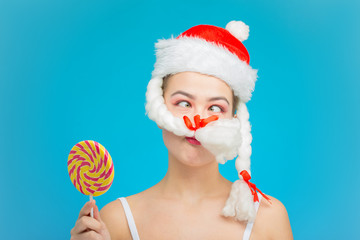 fun miss santa with candy and fake moustache on blue background