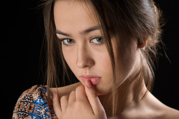 sad pensive young woman thinker on black background