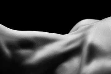 beautiful female slim neck with clavicle on black background, monochrome