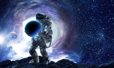 Obraz na płótnie Canvas Spaceman carry big planet. Mixed media